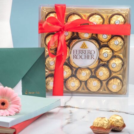 A box of Ferrero Rocher chocolates tied with a red ribbon