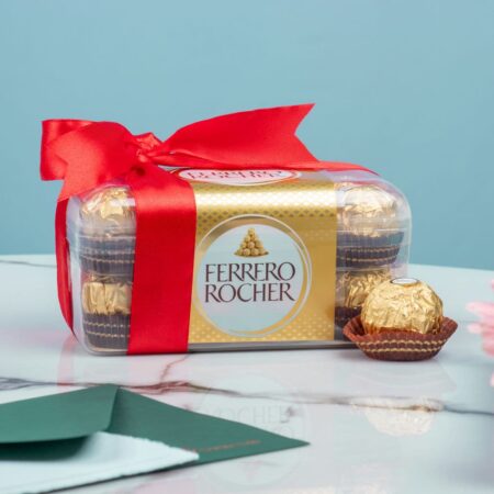 A box of Ferrero Rocher chocolates with a red bow and green envelope