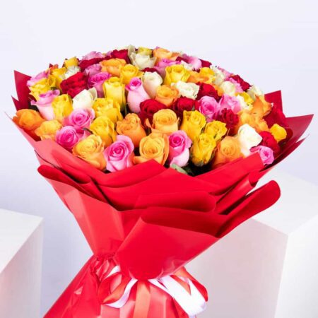 Close-up view of stunning mix of 100 roses in full bloom, featuring vibrant colors and wrapped in red eco-friendly paper. Available for delivery
