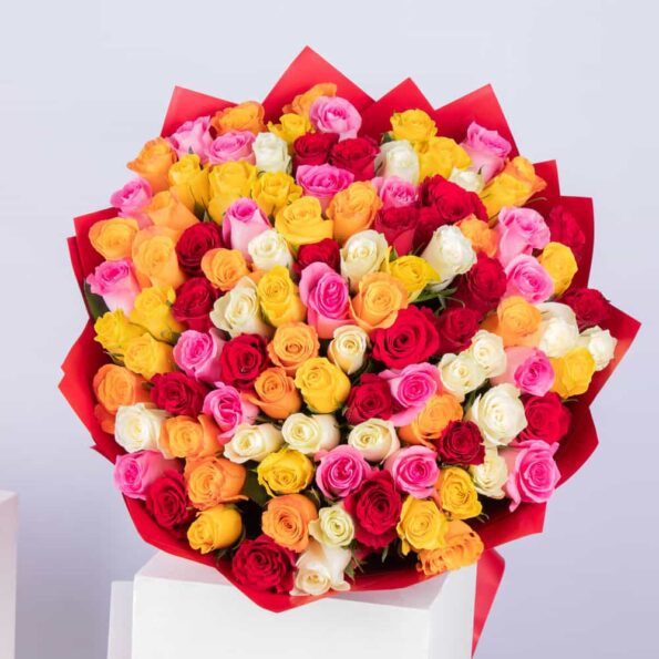 Top view of stunning mix of 100 roses in full bloom, featuring vibrant colors and wrapped in red eco-friendly paper. Available for delivery