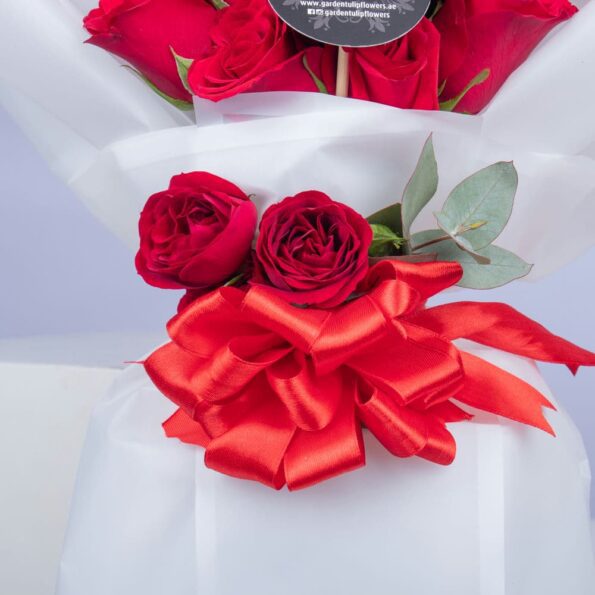 close up of red roses tied with red ribbon