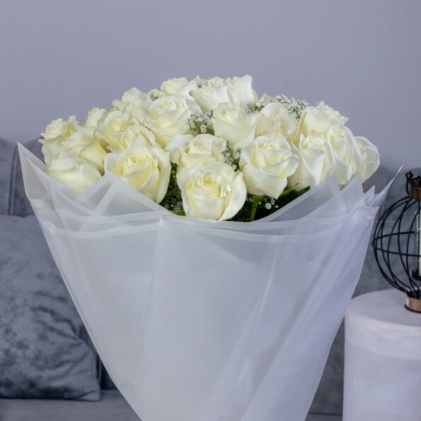 close up of white rose bouquet with baby breath