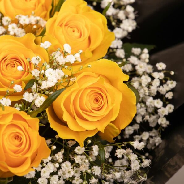 close up of yellow roses and baby breaths