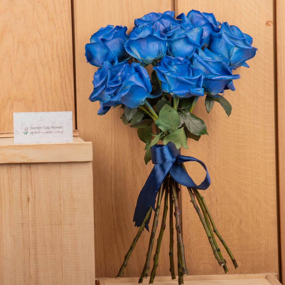 A bouquet of blue roses with a blue ribbon