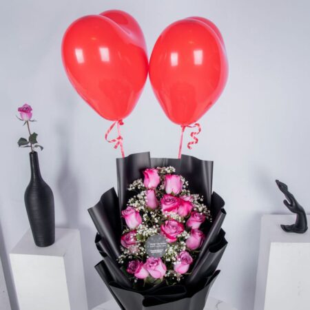 Pink rose bouquet with heart shaped red balloons