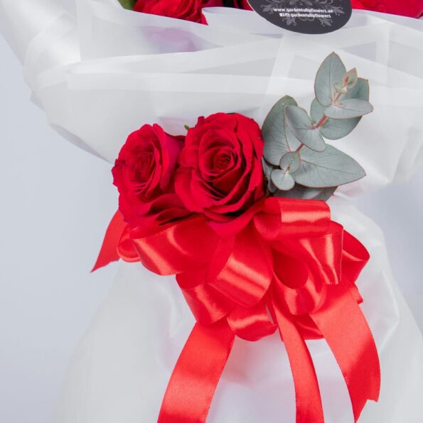 red roses tied in red ribbon