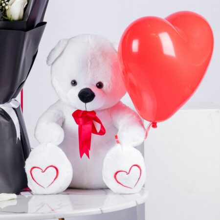 White teddy bear with heart shaped balloon