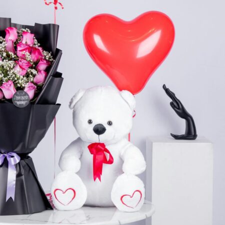 Bouquet of pink roses, teddy bear, and heart-shaped balloons