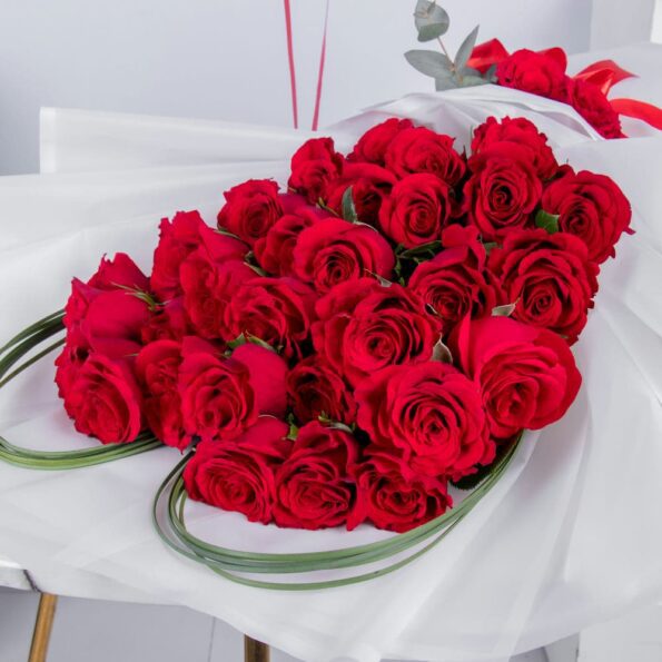 A close up view of Red Roses arranged in a Heart Shape with Steel Grass