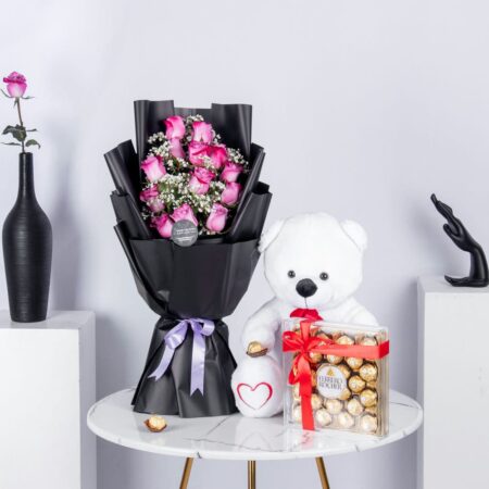 Bouquet of pink roses with white teddy bear and chocolates