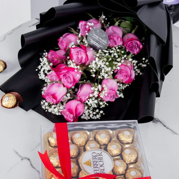 Bouquet of pink roses in a nice black wrapping with chocolates