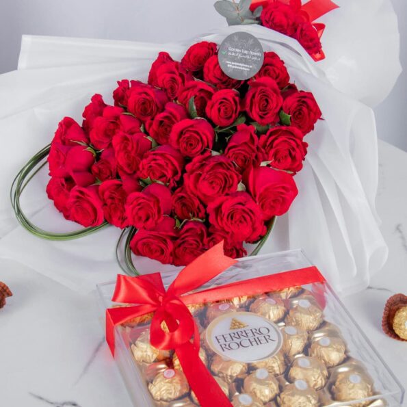 A close up view of Red Roses arranged in Heart Shape with Chocolates