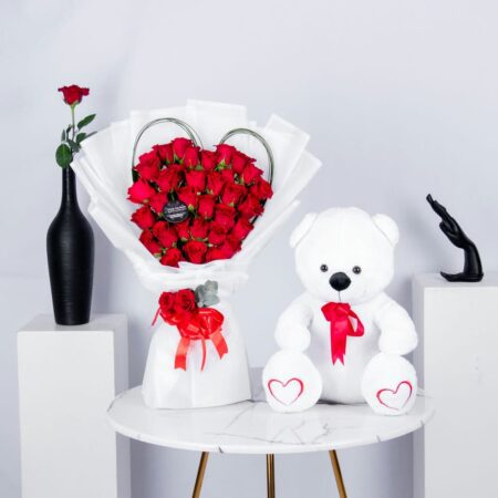 Red Roses arranged in a Heart Shape with Steel Grass and a White Teddy Bear