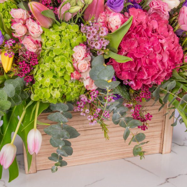 Stunning display of rare and fascinating flowers, meticulously arranged in a handcrafted wooden box.