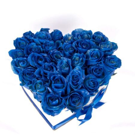 Blue roses arranged in heart shaped white box