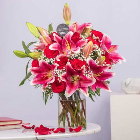 Pink lilies and red roses in a vase