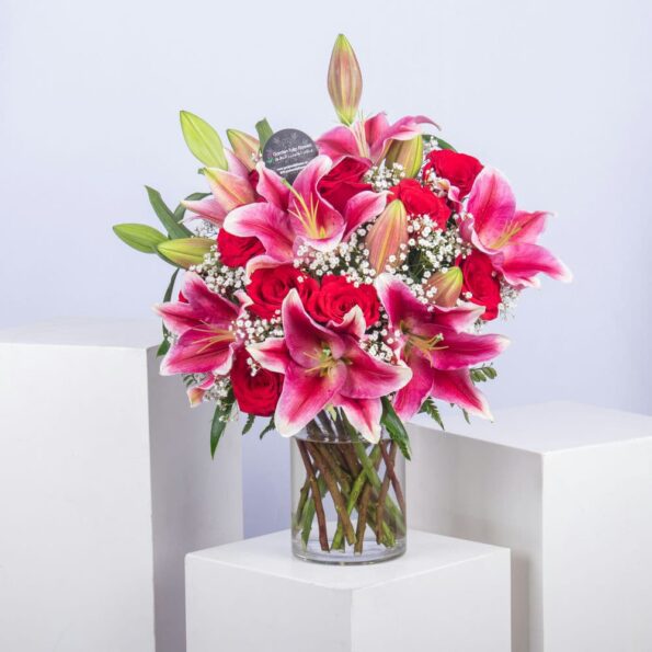 Pink lilies and red roses in a vase