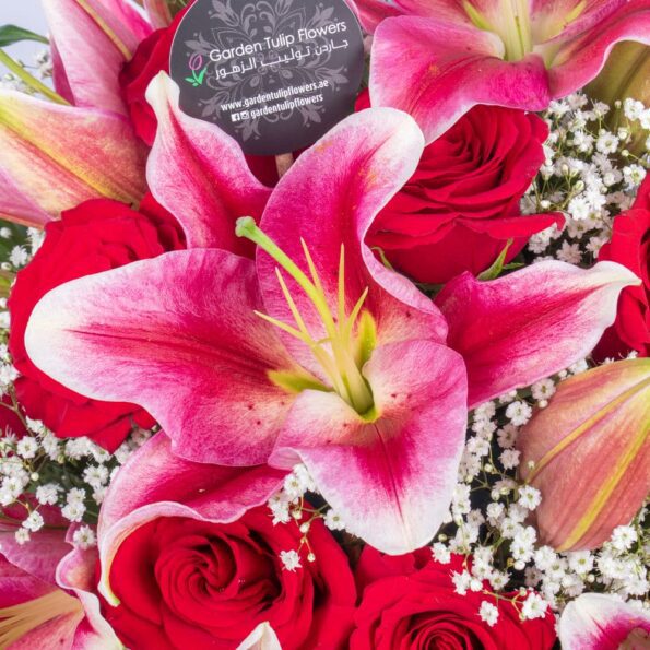 top view of pink lilies and red roses in a vase