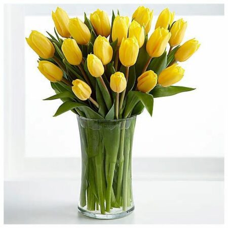 vase filled with yellow tulips