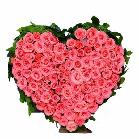 Pink roses arranged in a heart shape with fillers
