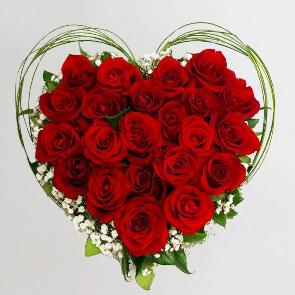 Red roses arranged in heart shape with baby's breath