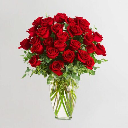 Red roses in a glass vase with fillers