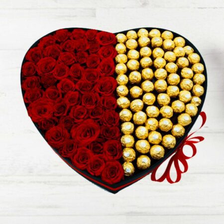 Red roses and chocolates arranged in a heart shaped box