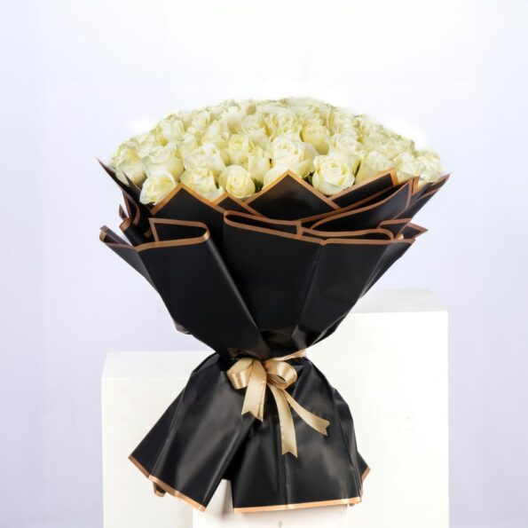 Full-bloom bouquet of 101 white roses, wrapped in eco-friendly satin paper and tied with a ribbon